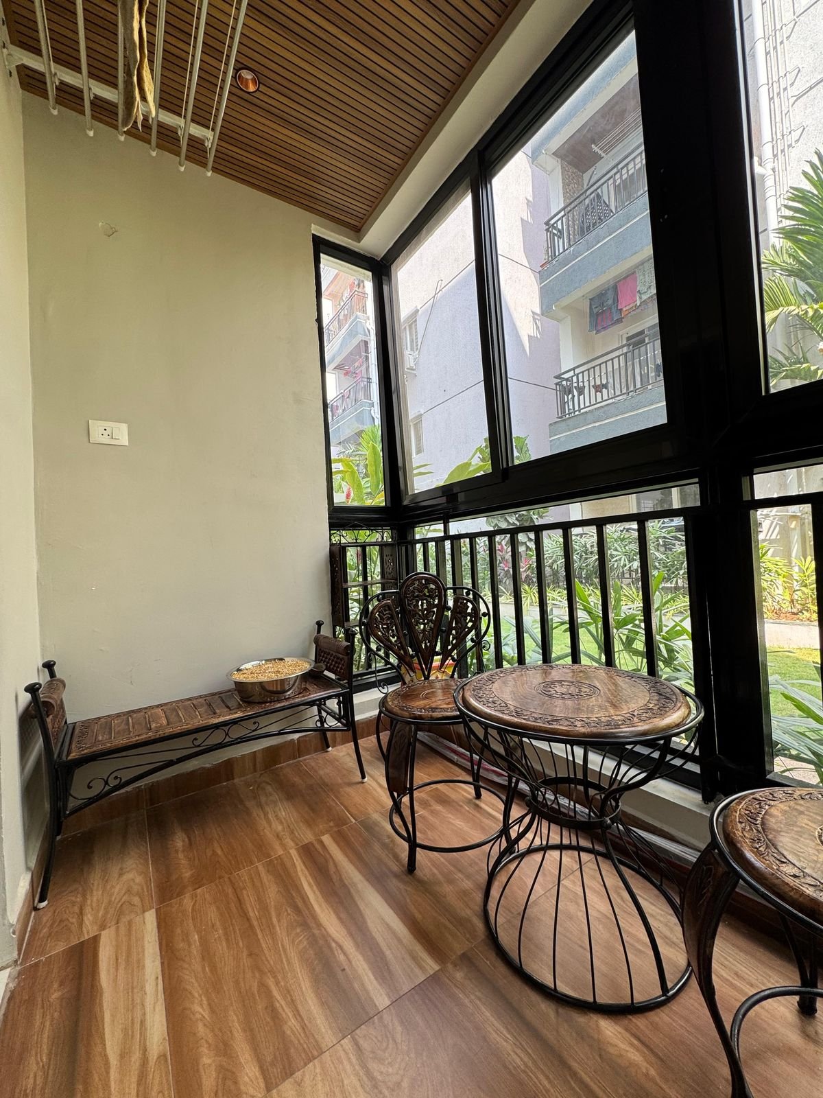 Warm wooden balcony seating area designed by Nikhila Nayini